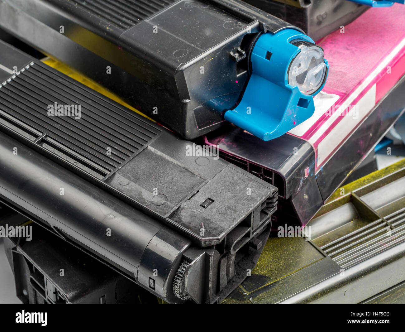Pile of used color laser printer toner cartridges Stock Photo