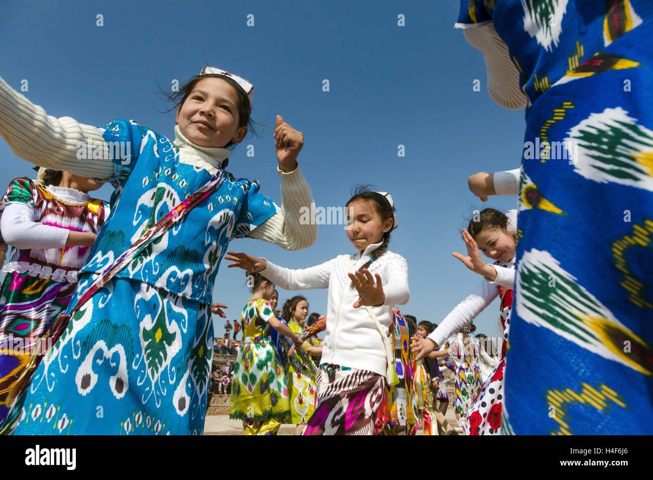 Girls dancing traditional oriental dance during the celebration of Navruz in a village in Tajikistan Republic Stock Photo