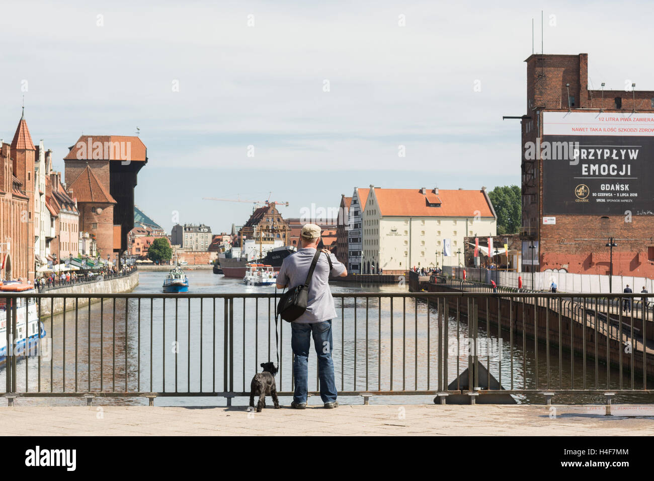 Gdansk - man taking a photograph of the classic view of Gdansk waterfront  and crane from the Green Bridge over the River Motlawa Stock Photo - Alamy