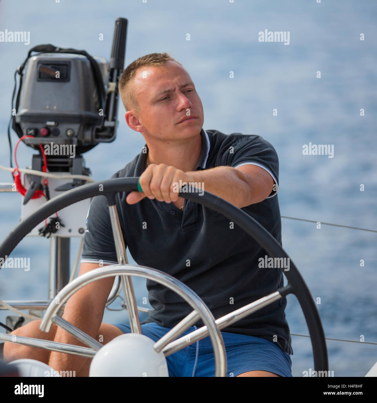 Skipper drive a sailing boat Stock Photo Alamy