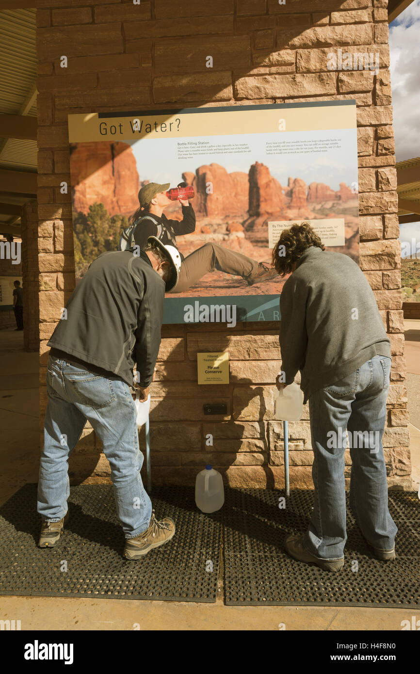 Park visitors filling water jugs at Arches National Park, Visitor Center Stock Photo