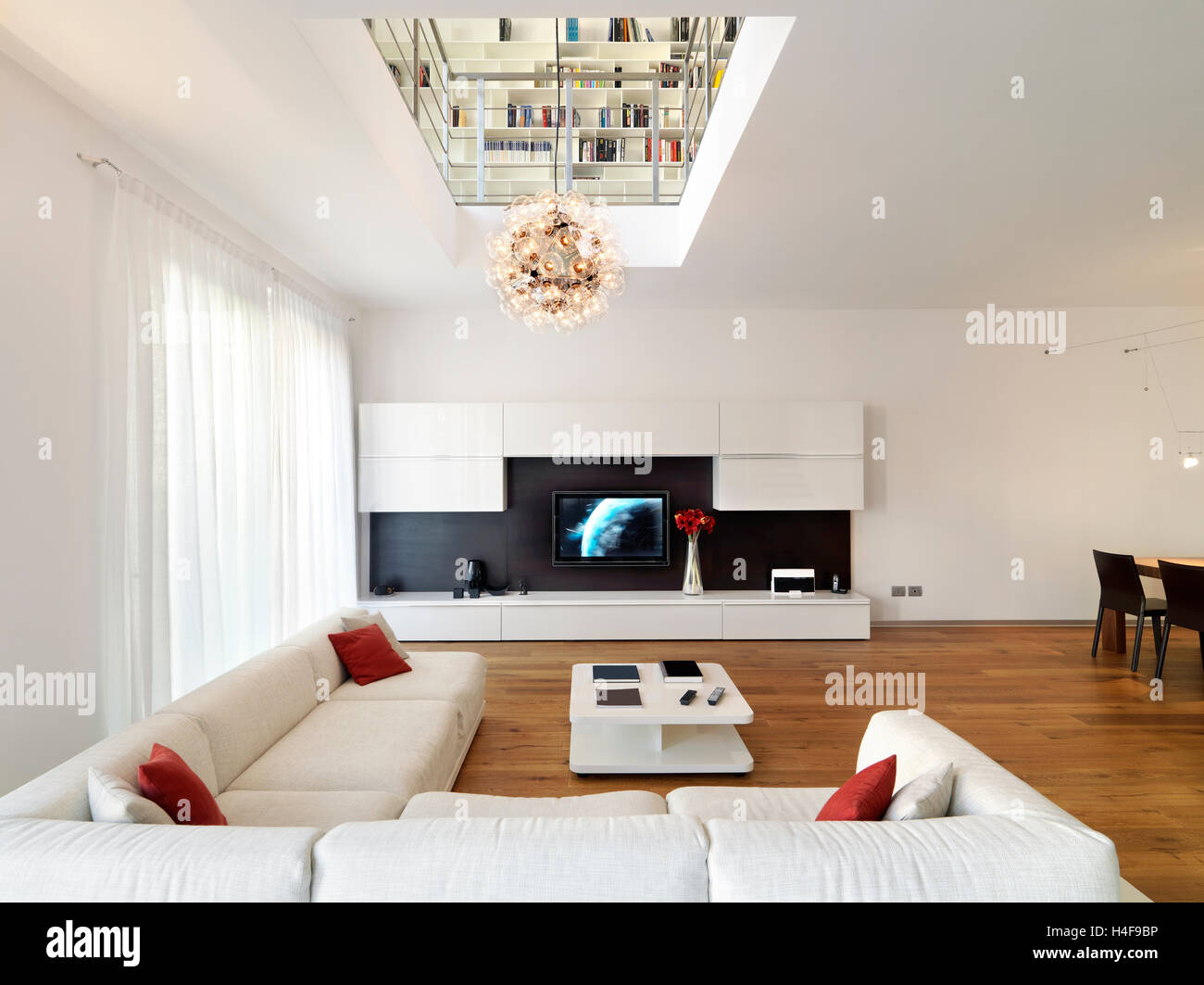 interior view of a modern living room in foreground the sofa the flooring is made of wood Stock Photo