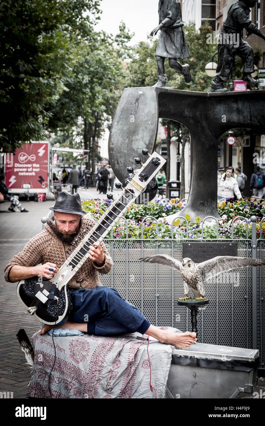 Buskers playing a Grand Pro Tun Sitar a Indian instrument in Abington ...