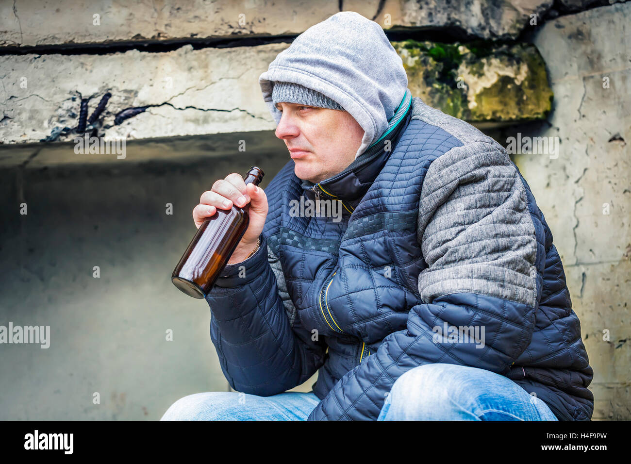 Man with beer bottle under the bridge Stock Photo Alamy