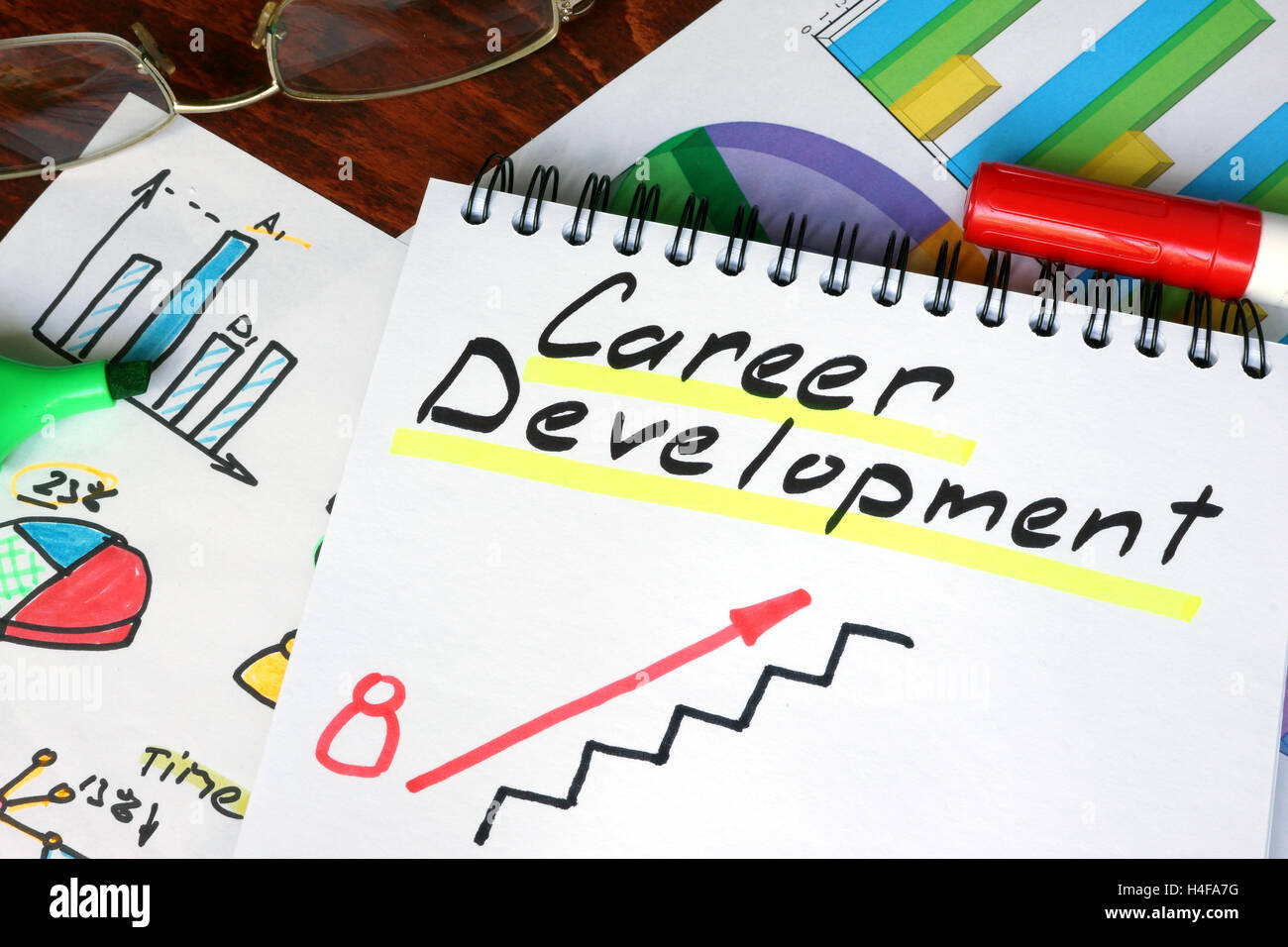 Notepad with Career Development on a wooden surface. Stock Photo