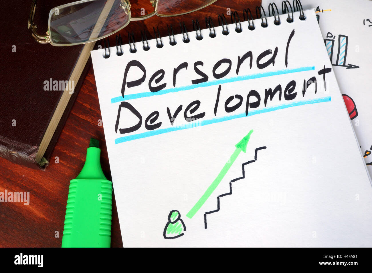 Notepad with personal development on a wooden surface. Stock Photo
