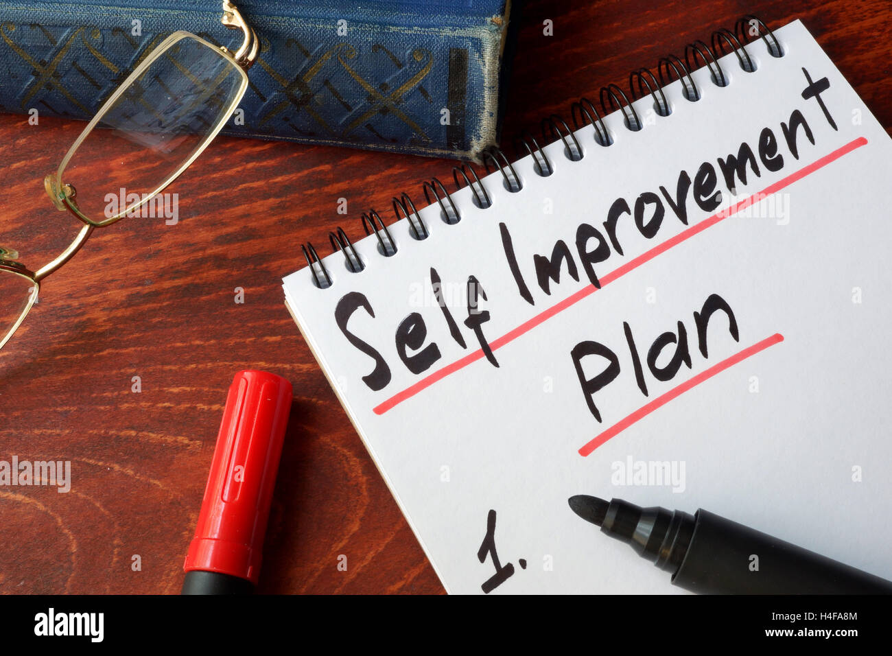 Self improvement concept written in a notepad. Stock Photo