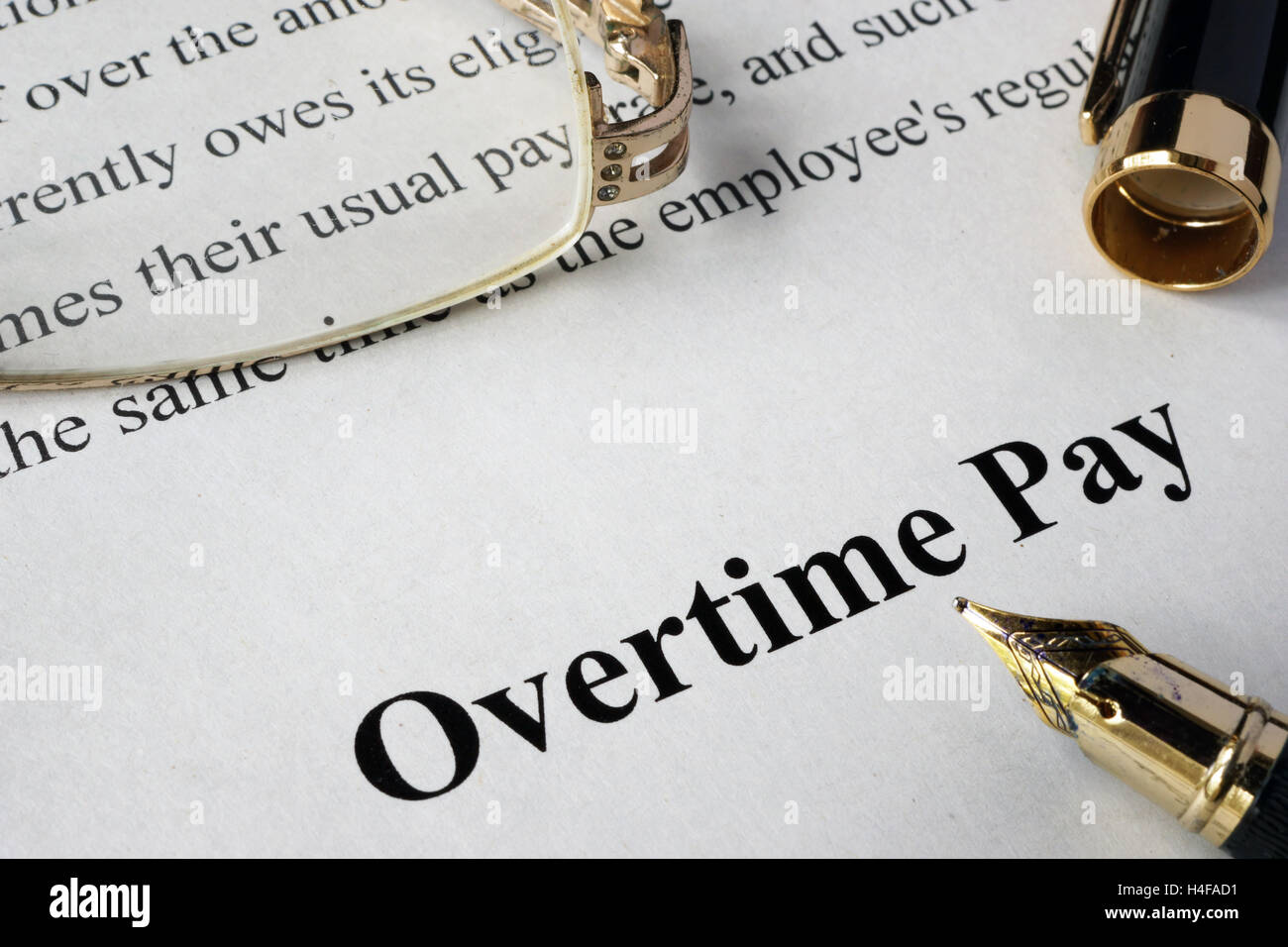 Overtime pay concept written on a paper. Stock Photo