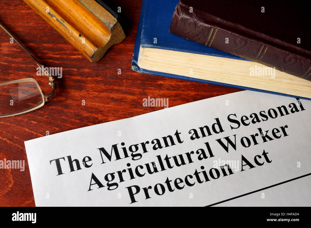 The Migrant and Seasonal Agricultural Worker Protection Act and a book. awpa/mspa Stock Photo