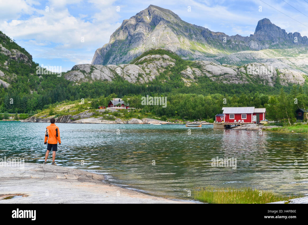 Explorer and cabin by the fjord in Northern Norway: outdoors, fjords and mountains Stock Photo
