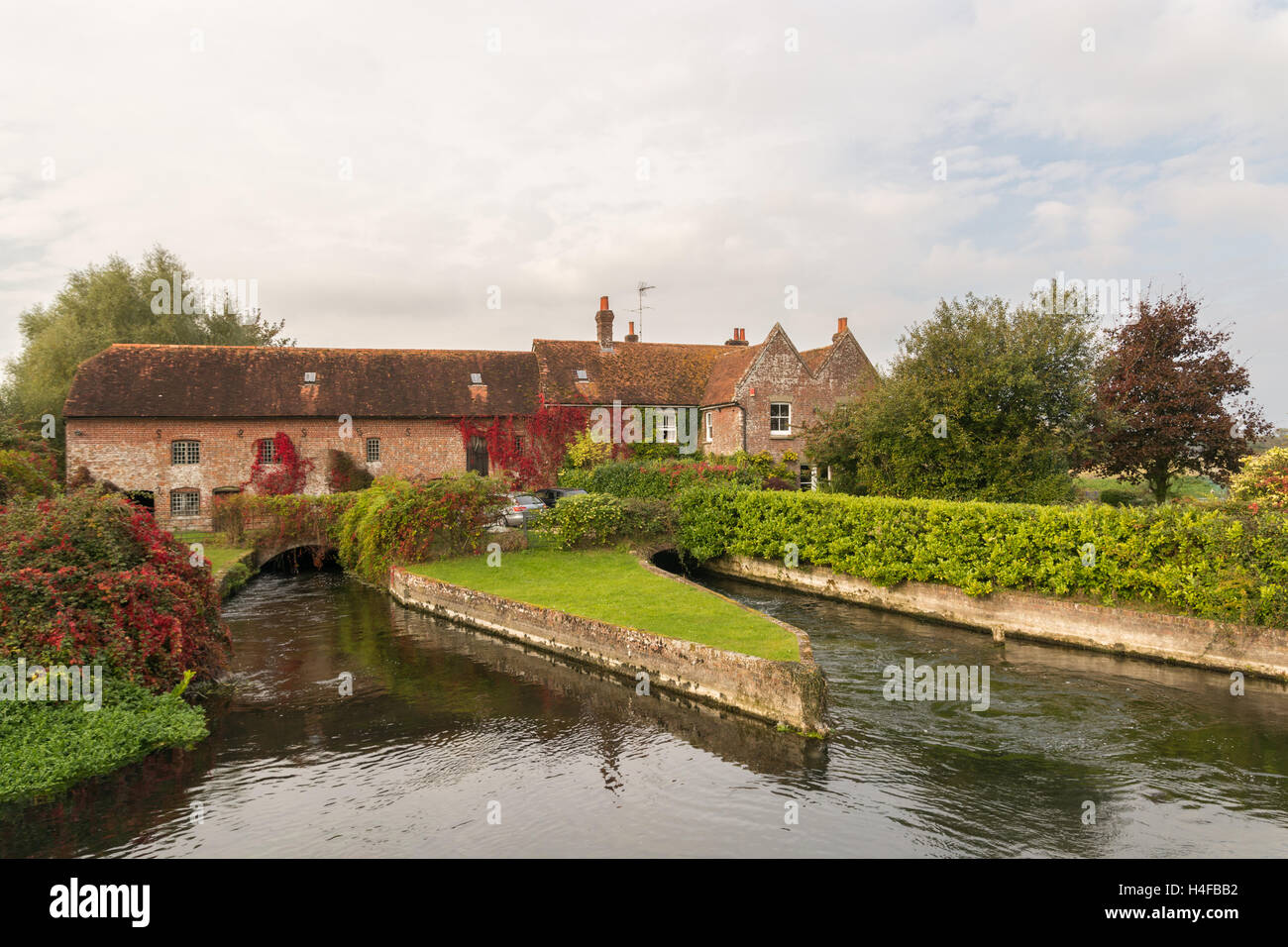 The grade II listed Mill House over the River Avon at Breamore, Hampshire, UK, between Downton and Fordingbridge. Stock Photo