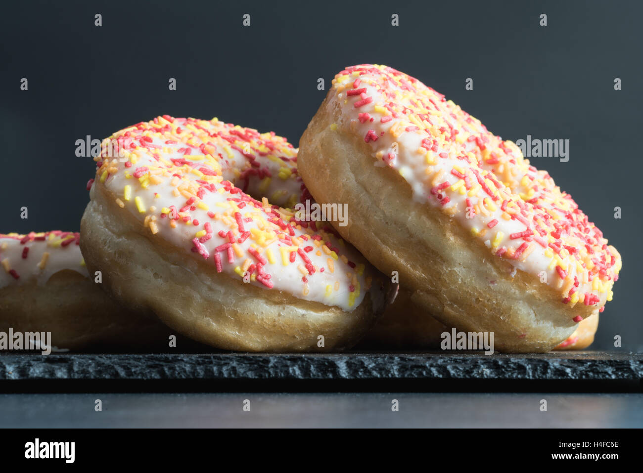 A side view of donuts on a slate. Stock Photo