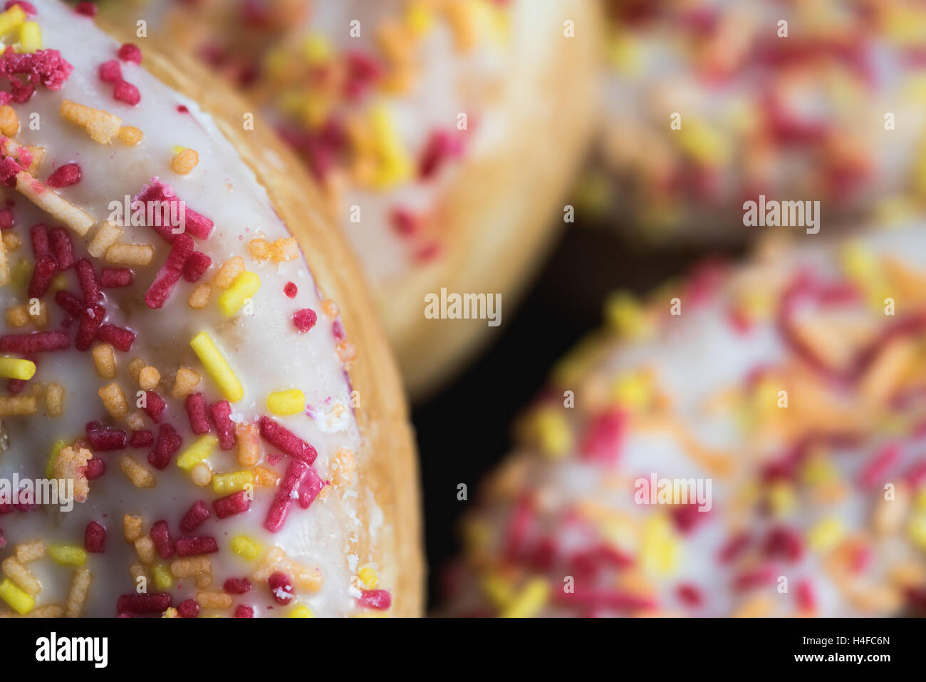 A macro close up of four iced donuts. Stock Photo