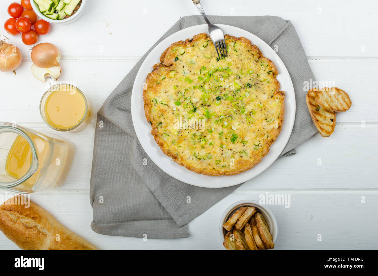 Omelette with zucchini and mozzarella cheese, scallions, fresh orange juice and crispy toast Stock Photo