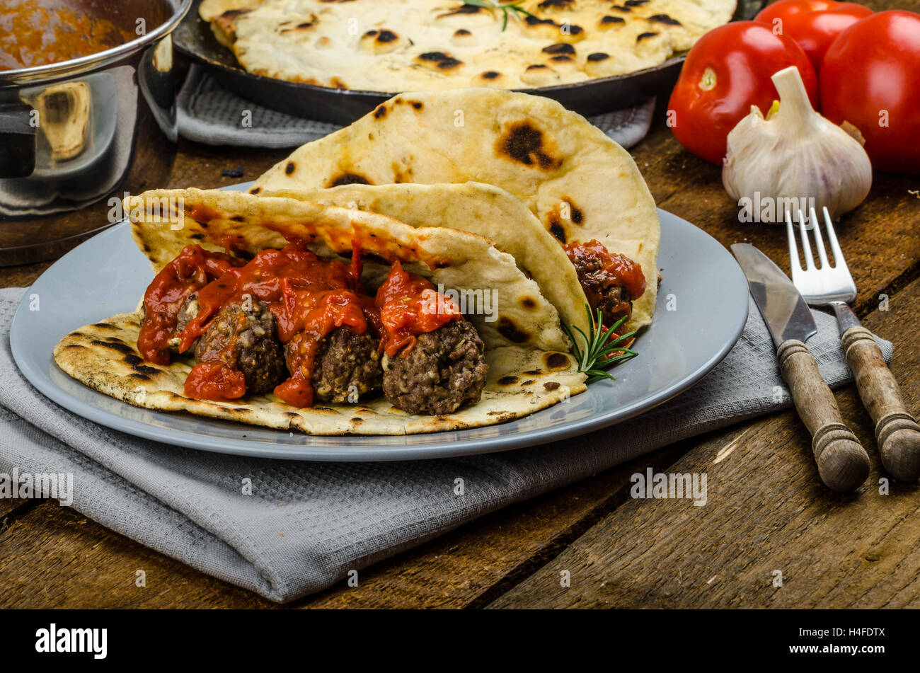 Indian naan with meatballs and tomato sauce, spicy sauce and exotic