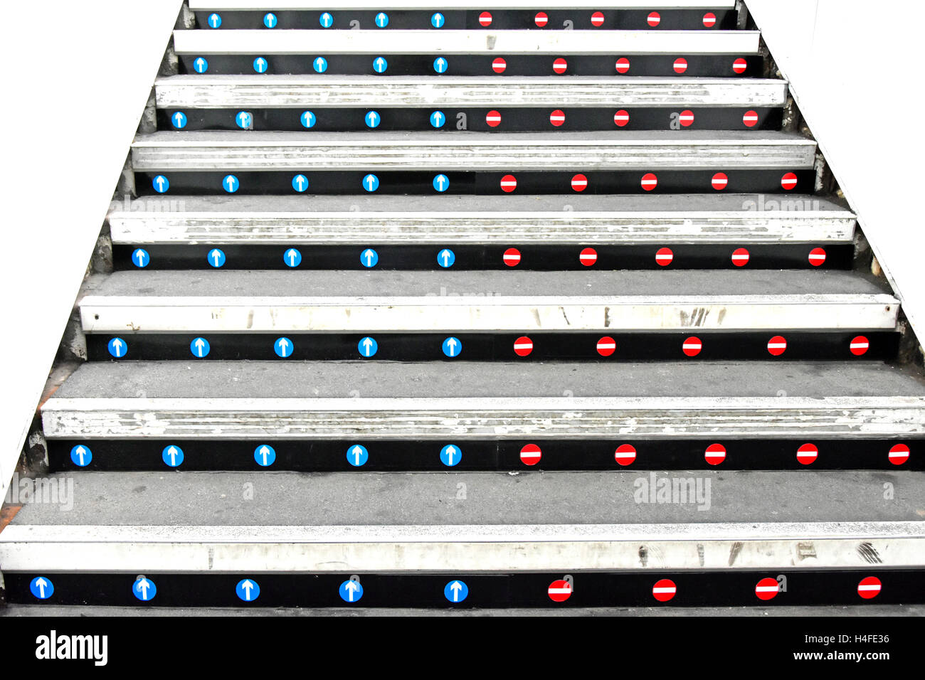 No entry stickers on stair risers of uk railway station platform staircase to indicate correct up & down access those coming down see nothing Stock Photo