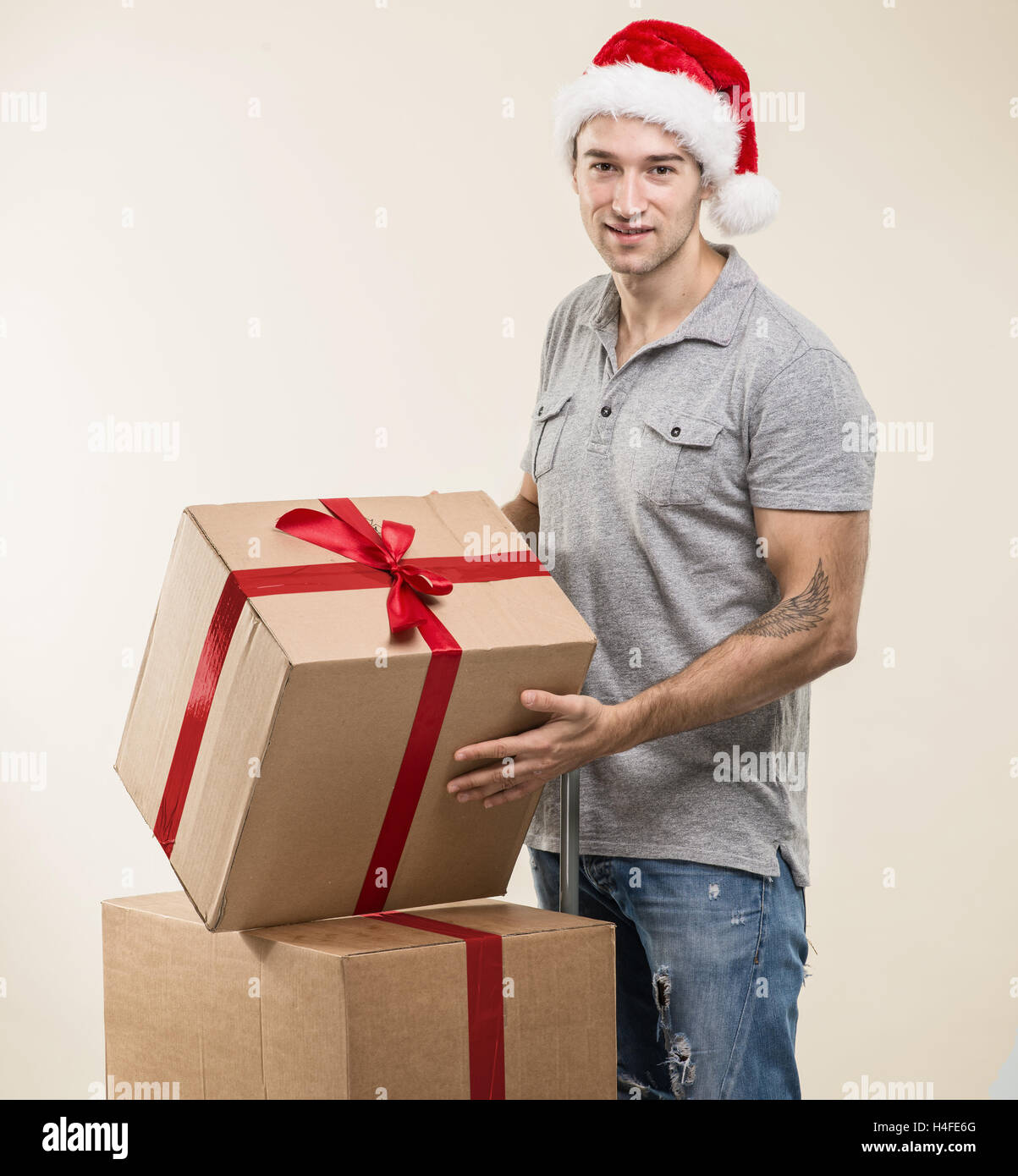 Handsome man in santa hat - hand gift box Stock Photo