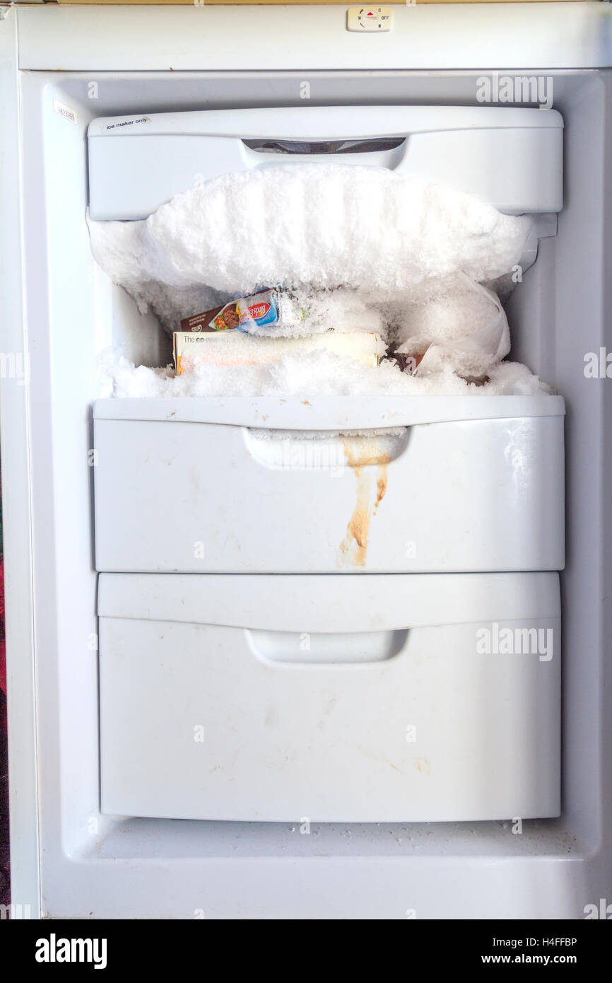 A upright freezer in need of defrosting. Stock Photo