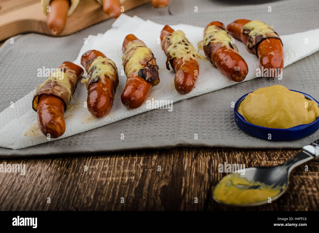Fried sausage in a robe of bacon and cheese, hot dog, czech Stock Photo