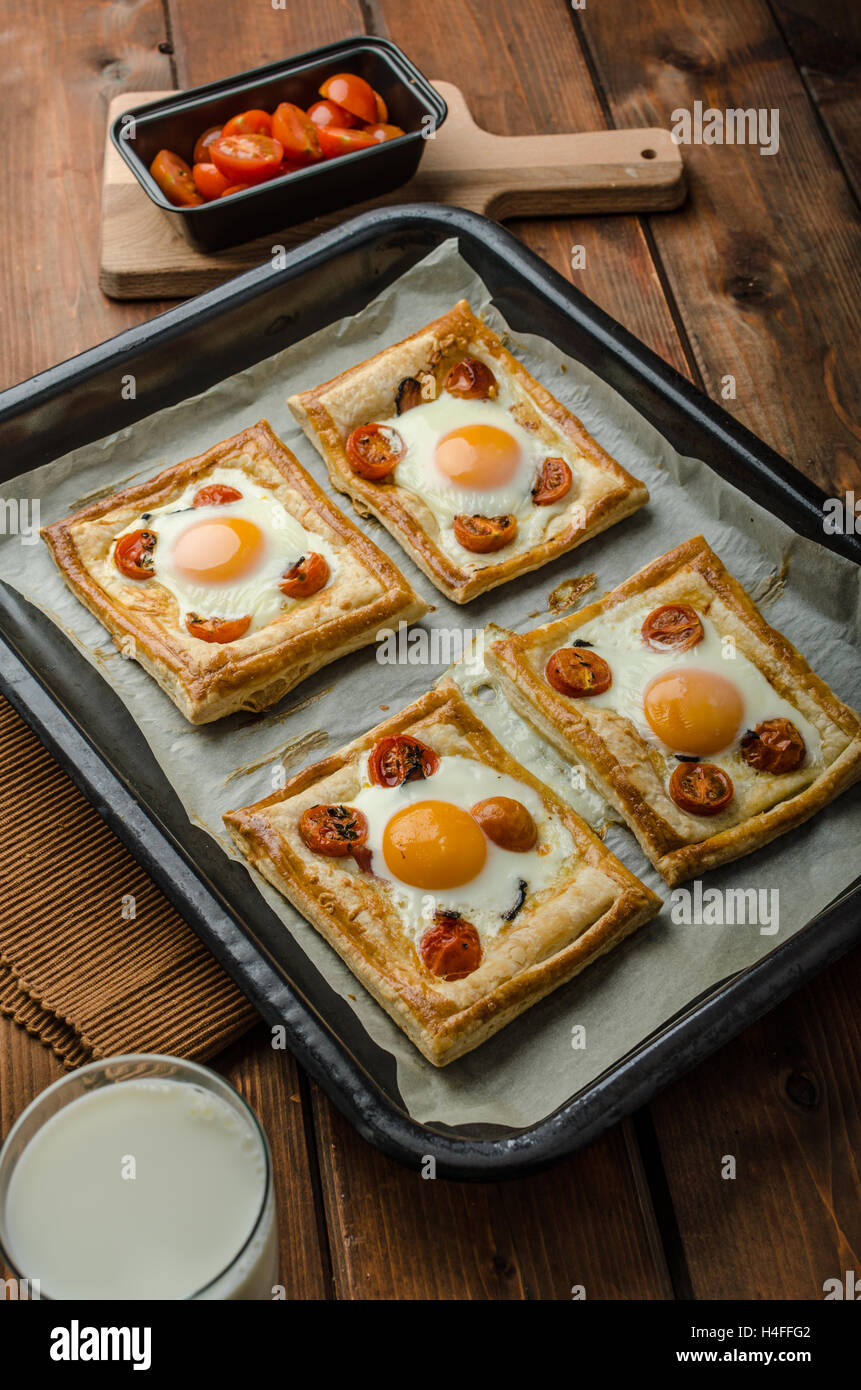 Tomato, Egg, and Prosciutto Tart from puff pastry, baked in oven Stock