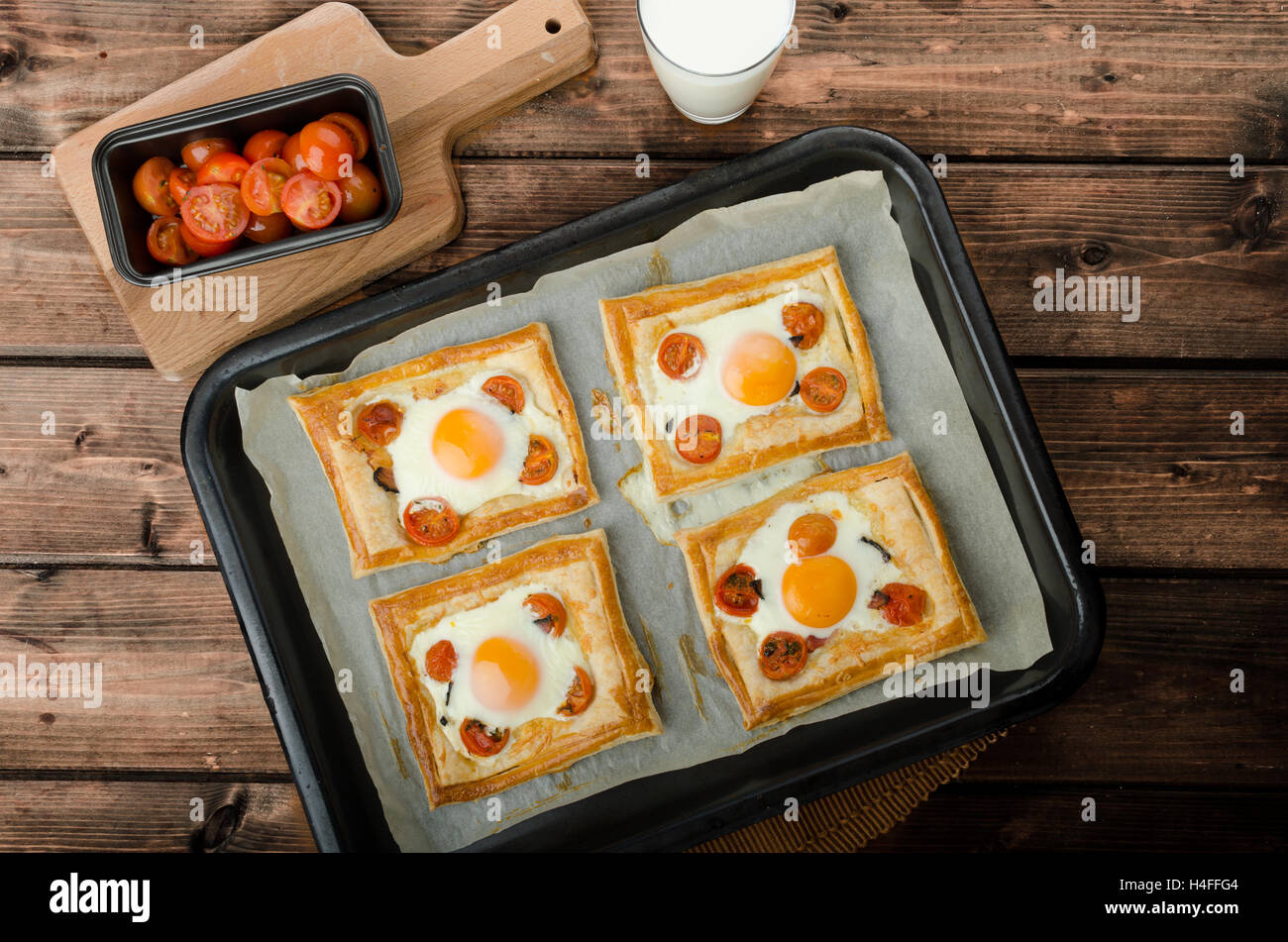 Tomato, Egg, and Prosciutto Tart from puff pastry, baked in oven Stock