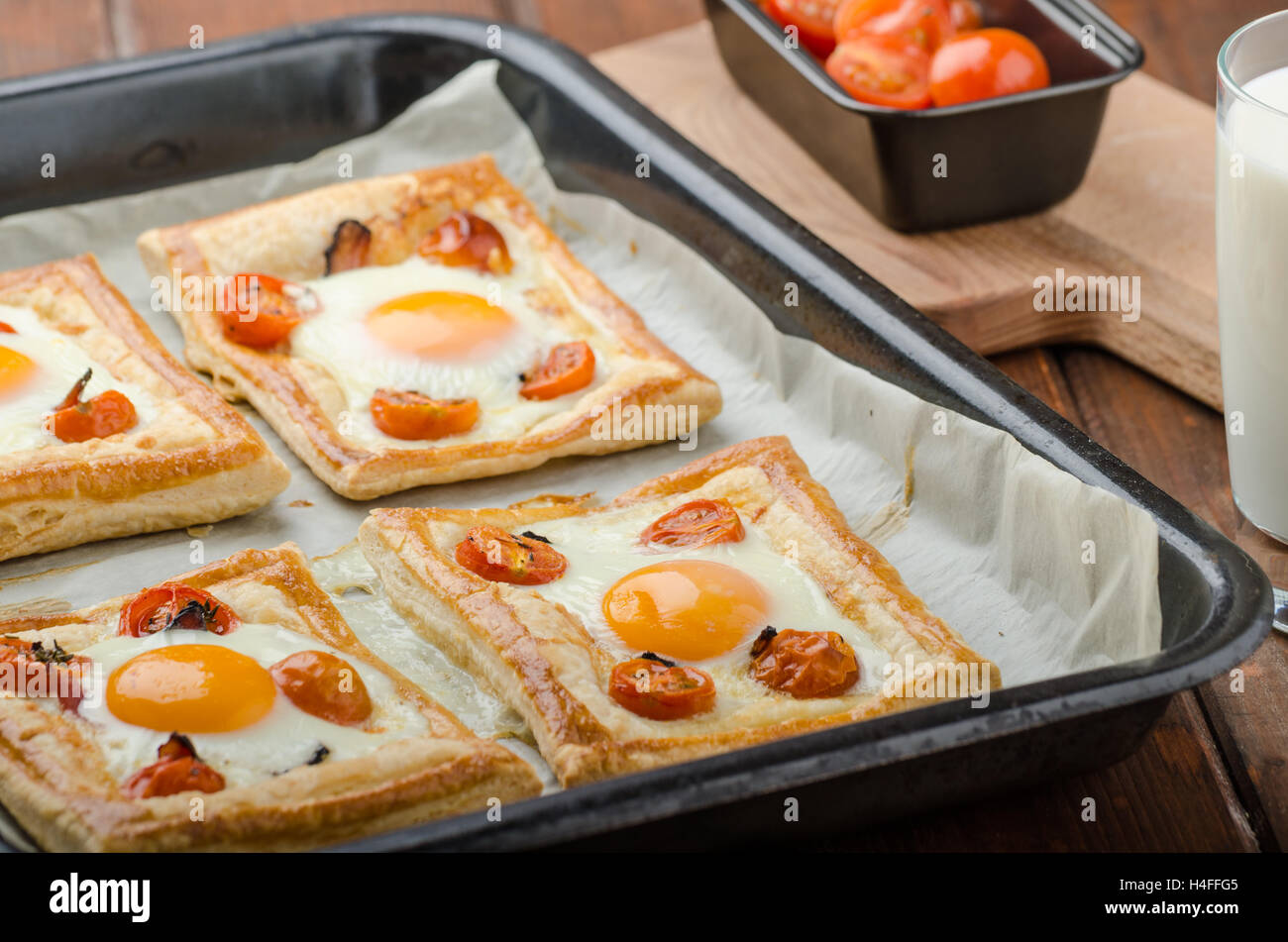 Tomato, Egg, and Prosciutto Tart from puff pastry, baked in oven Stock