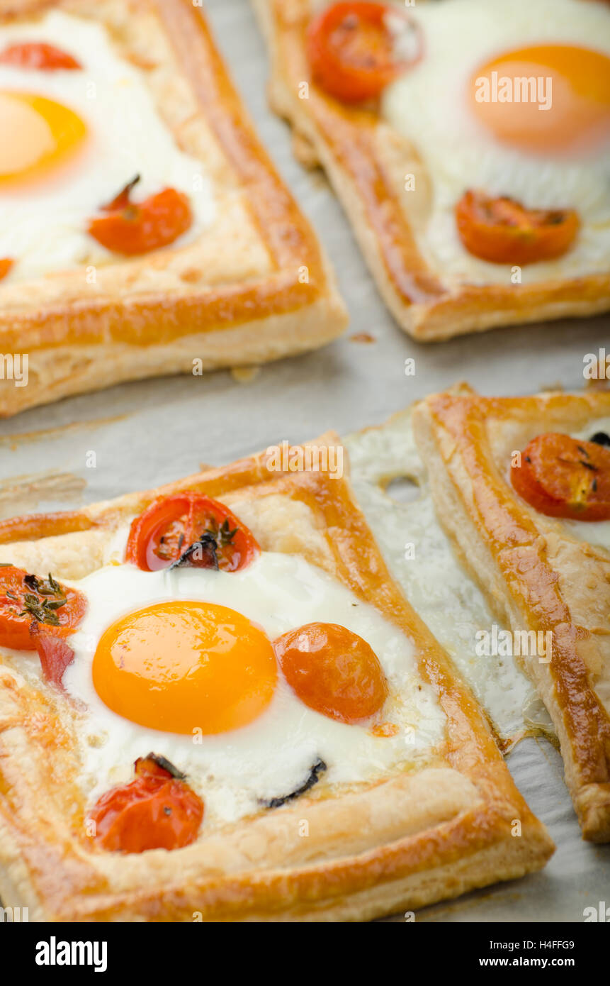 Tomato, Egg, and Prosciutto Tart from puff pastry, baked in oven Stock