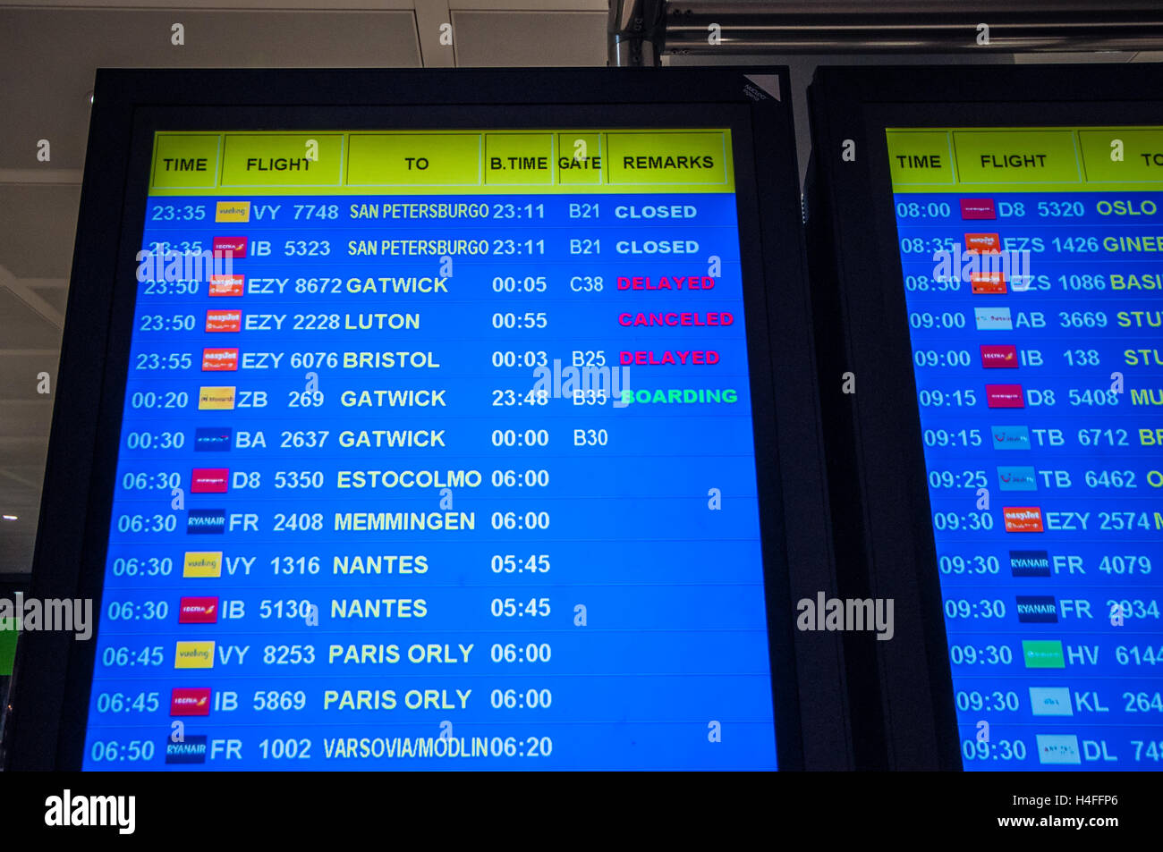 Departures board at Alicante Airport in Spain with a cancelled and delayed flights. Airline and flight numbers. Boarding gates. Information screen Stock Photo