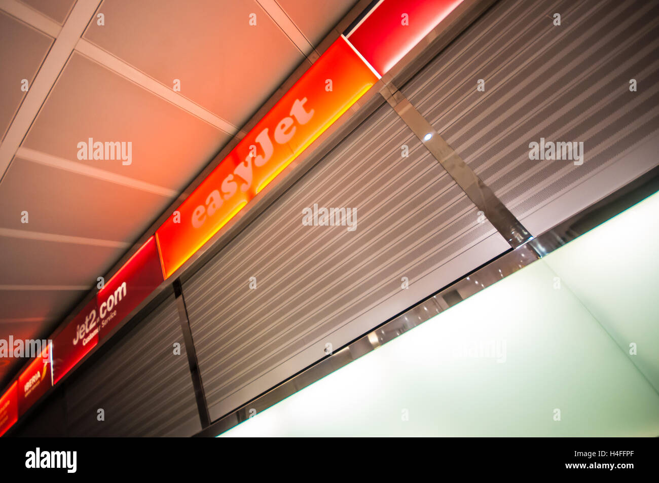Closed easyJet, Jet2 and Norwegian airline help desks at Alicante airport, Spain. Shut shutters Stock Photo