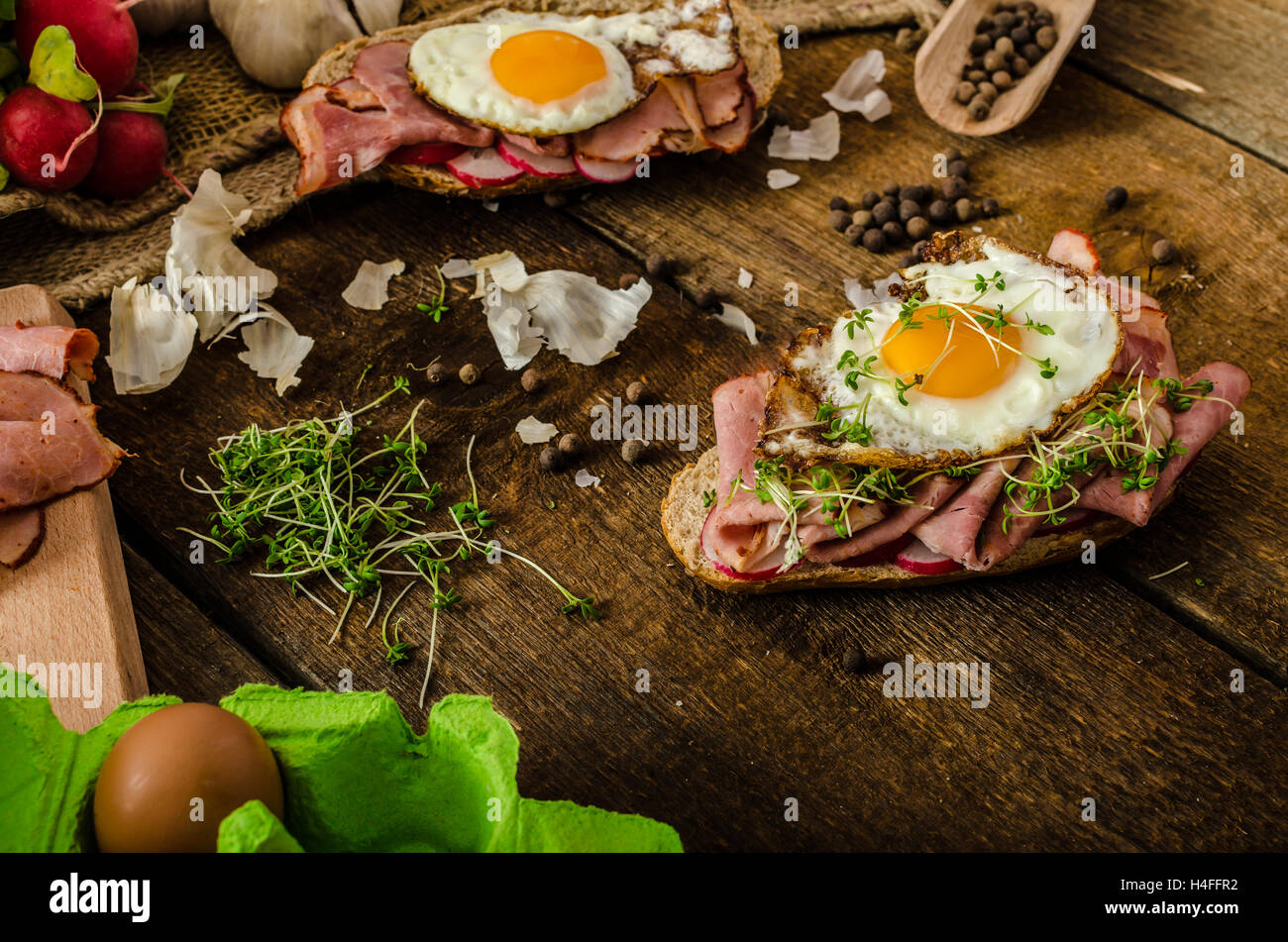 Smoked ham sandwich, rustic bread with bullseye egg, microgreens and