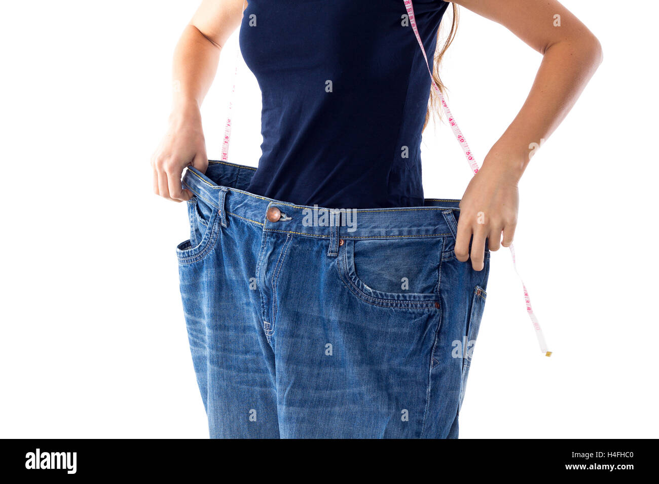 Woman wearing jeans of much bigger size Stock Photo Alamy