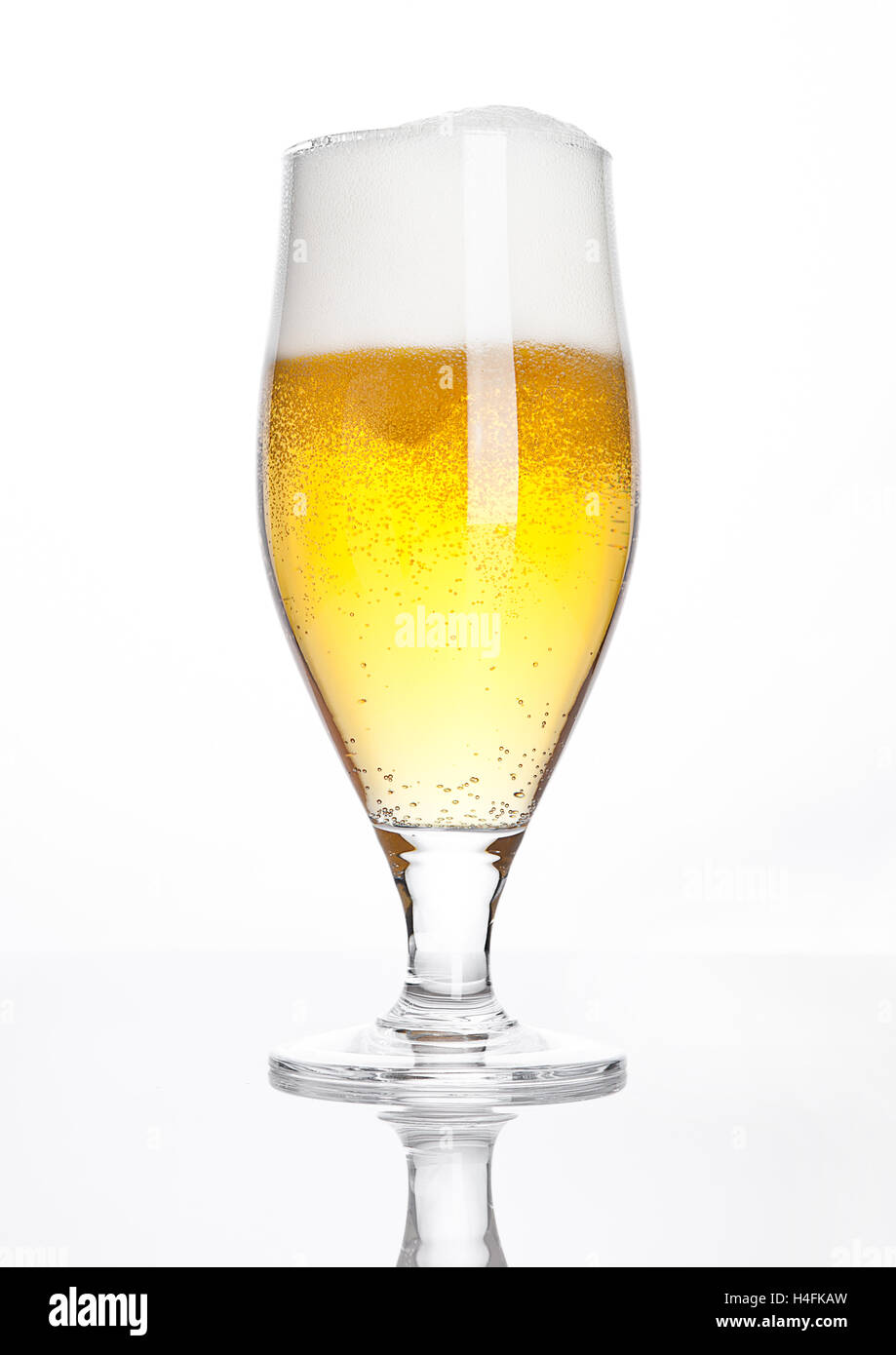Glass of beer cider with foam golden color on white background Stock