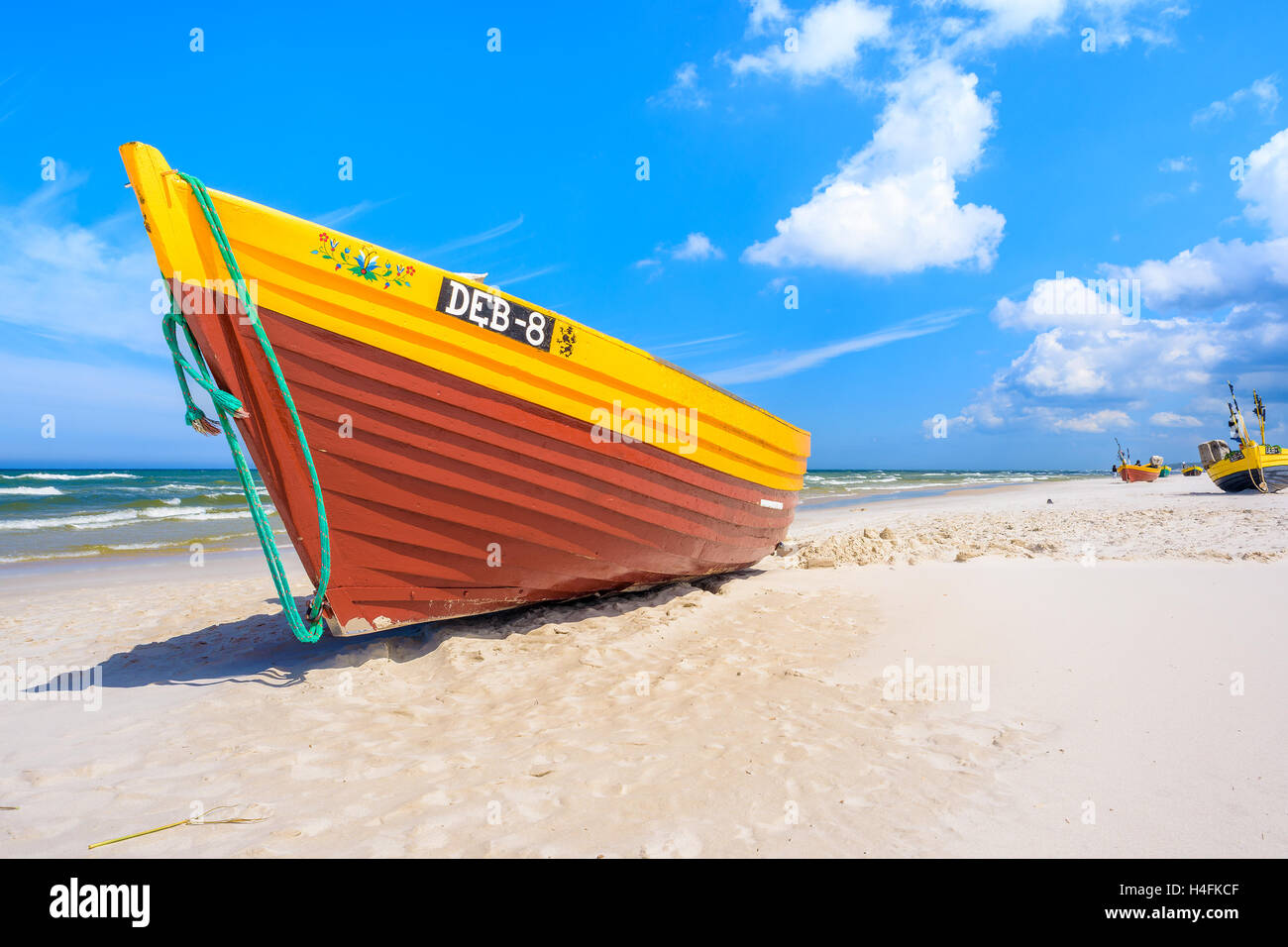 BALTIC SEA BEACH, POLAND - JUN 18, 2016: Colorful fishing boat on sandy Debki beach. Poland's coastline has length of 770 km. Stock Photo