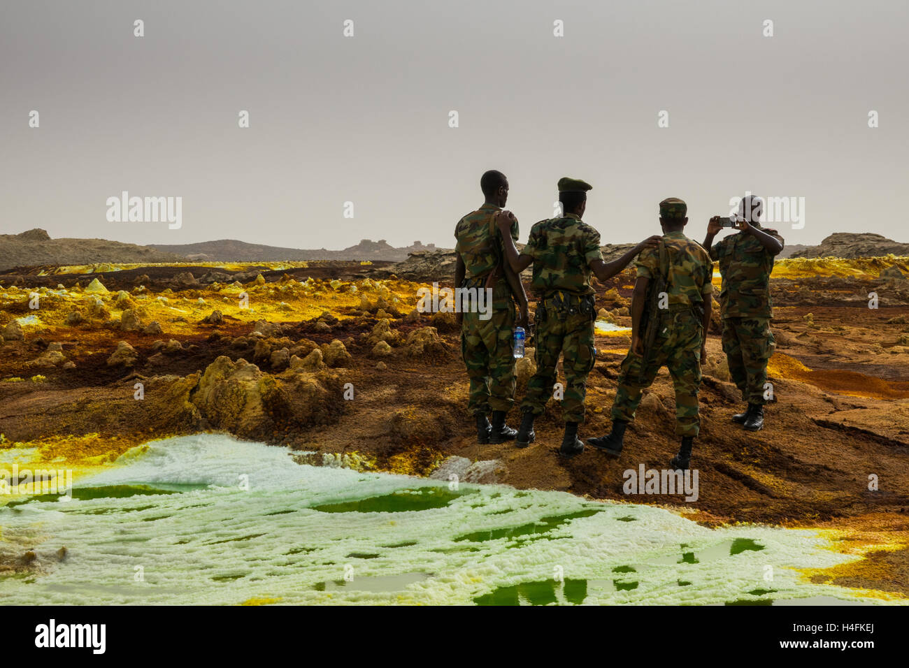 a group of Ethiopian Army soldiers pose for a photo at Dallol, a patch of vibrant chemical salts in the Danakil desert, Ethiopia Stock Photo
