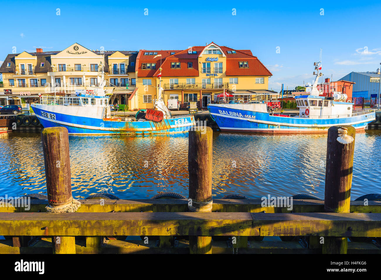 LEBA PORT, POLAND - JUN 18, 2016: fishing boats mooring in Leba port at sunset time. Leba is famous for large port located at Ba Stock Photo