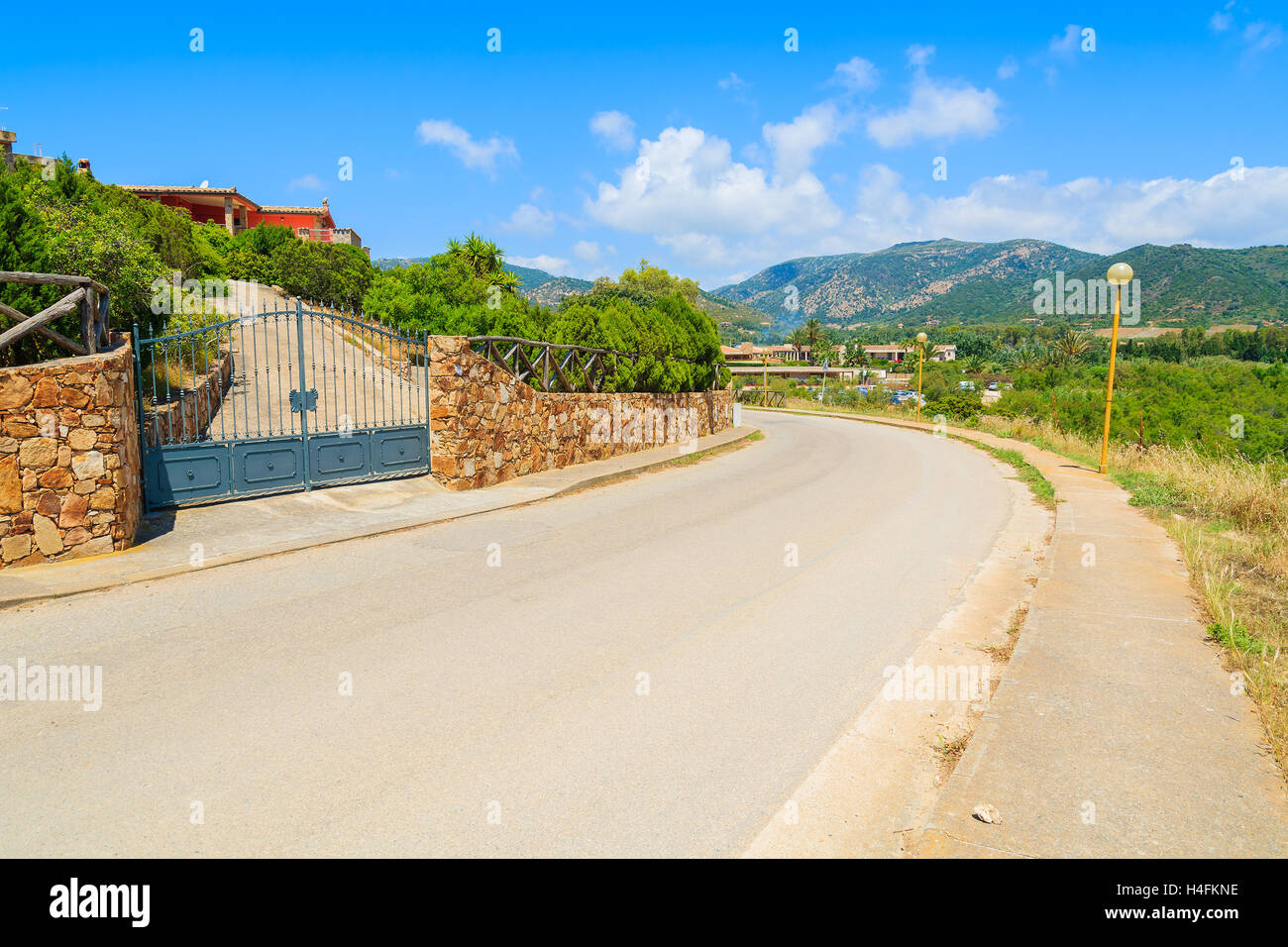 Scenic road in countryside landscape of Sardinia island near Chia beach on sunny summer day, Italy Stock Photo