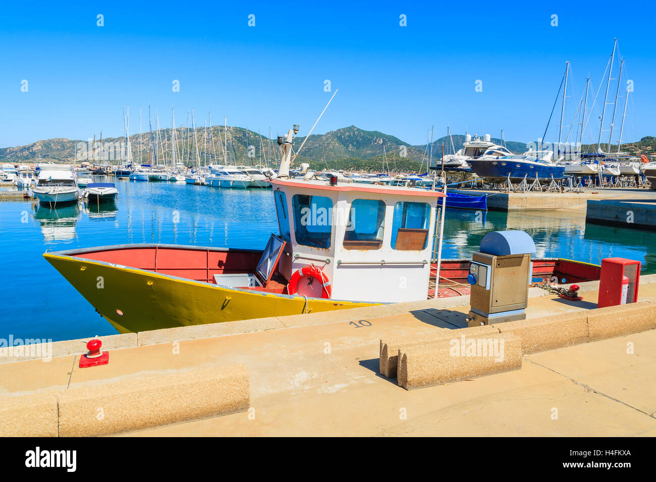 Fishing boat in harbour of Porto Giunco, Sardinia island, Italy Stock Photo
