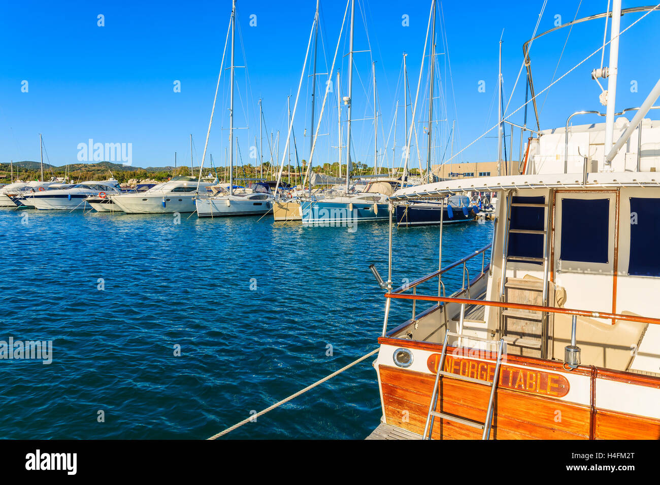 PORTO GIUNCO PORT, SARDINIA - MAY 27, 2014: yacht boats mooring in PortoGiunco port. Many tourists visit Sardinia island in summer time and sail along the coast. Stock Photo