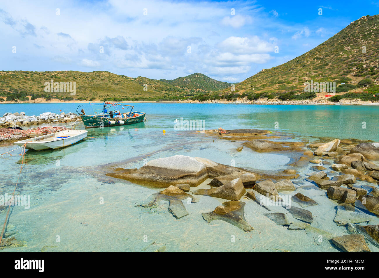 Punta Molentis bay with old fishing boats on sea water and beach view, Sardinia island, Italy Stock Photo