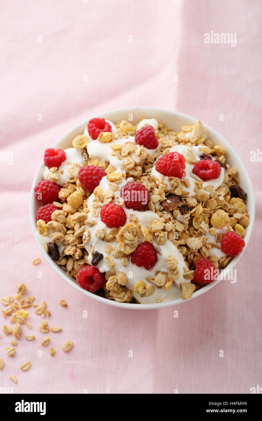 Breakfast bowl with raspberry muesli, food close-up Stock Photo