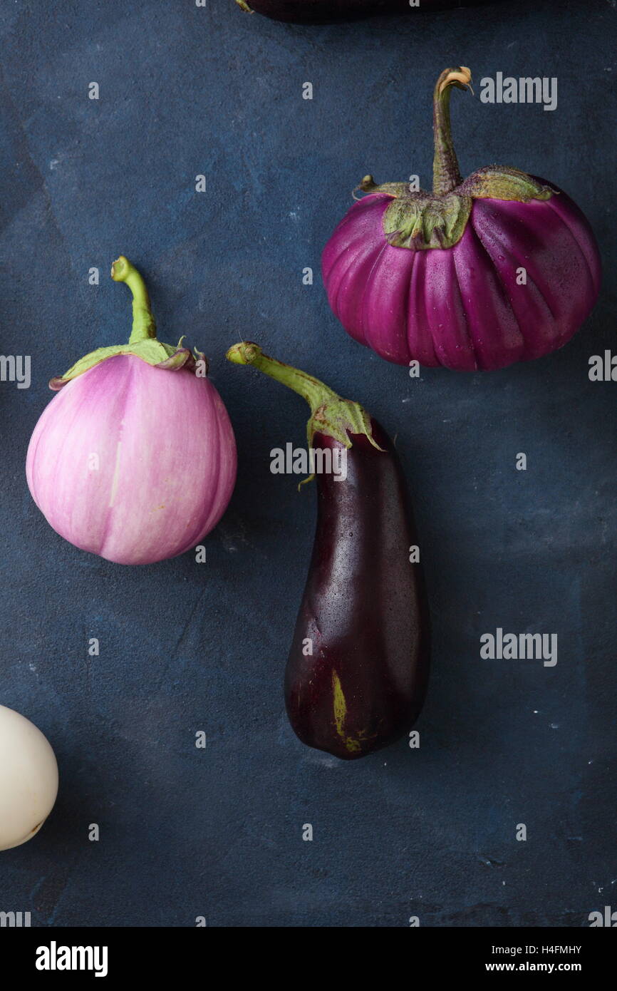 Organic eggplants on stone background, food above Stock Photo