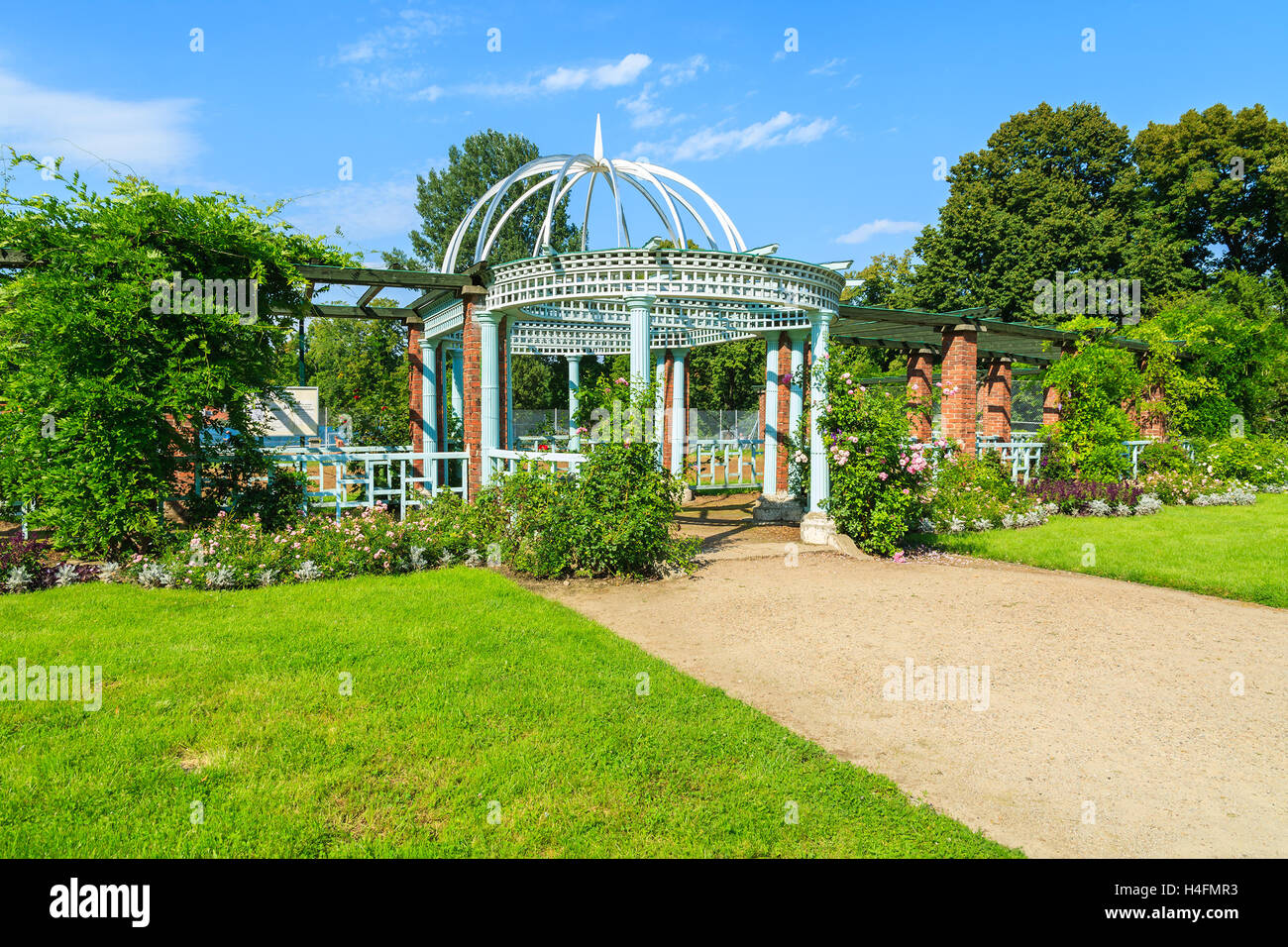 Alley in gardens of beautiful Lancut castle on sunny summer day, Poland Stock Photo