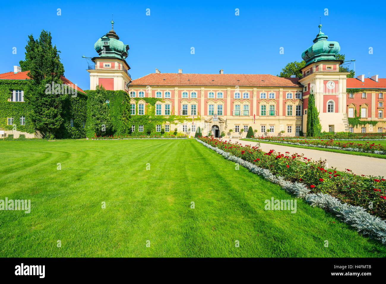 Green gardens of beautiful Lancut castle on sunny summer day, Poland Stock Photo
