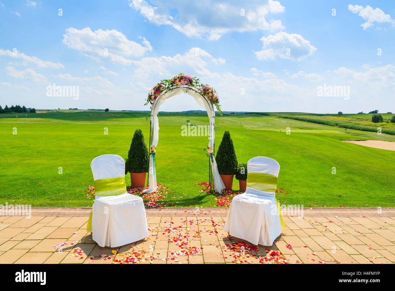 Arch and two white chairs in golf club prepared for weeding ceremony, Poland Stock Photo