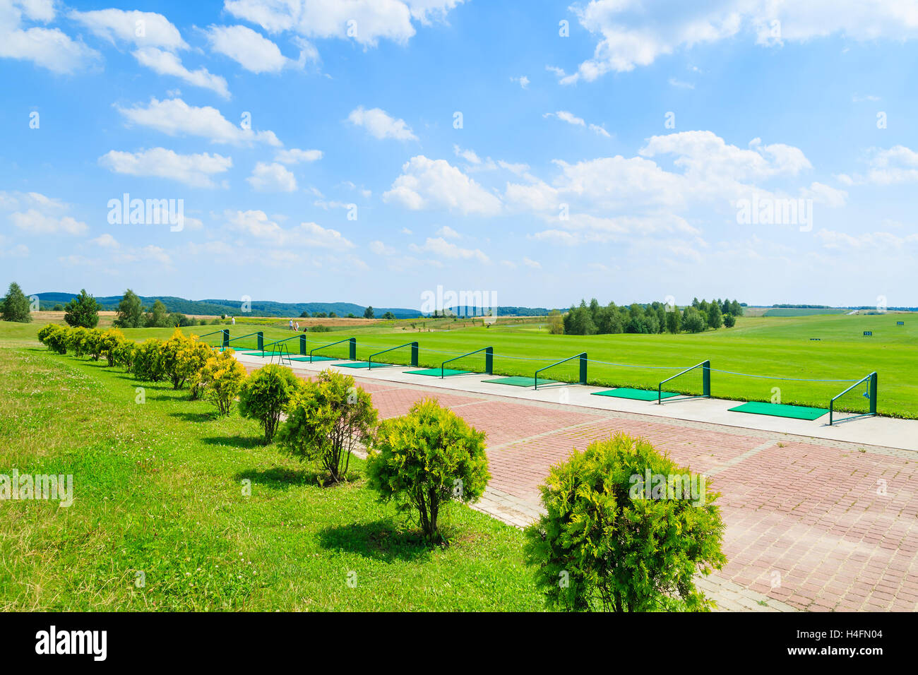 PACZULTOWICE GOLF CLUB, POLAND - AUG 9, 2014: golf course green play area in Paczultowice village on sunny summer day, Poland. Golfing is becoming a popular sport among wealthy people from Krakow. Stock Photo