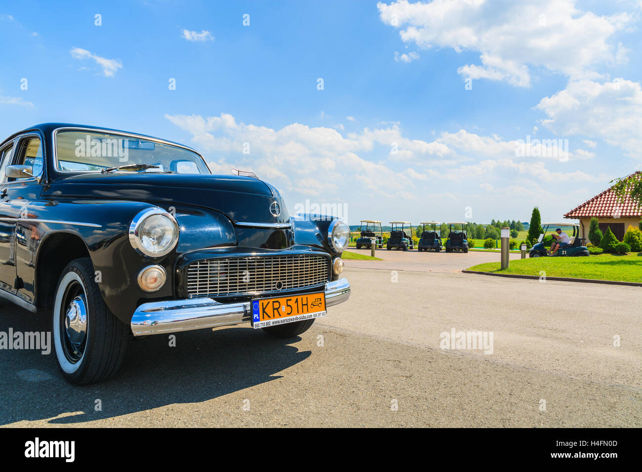 PACZULTOWICE GOLF CLUB, POLAND - AUG 9, 2014: old classic car parks on street in Paczultowice Golf Club. Vintage cars are popular to drive people to weeding ceremony. Stock Photo