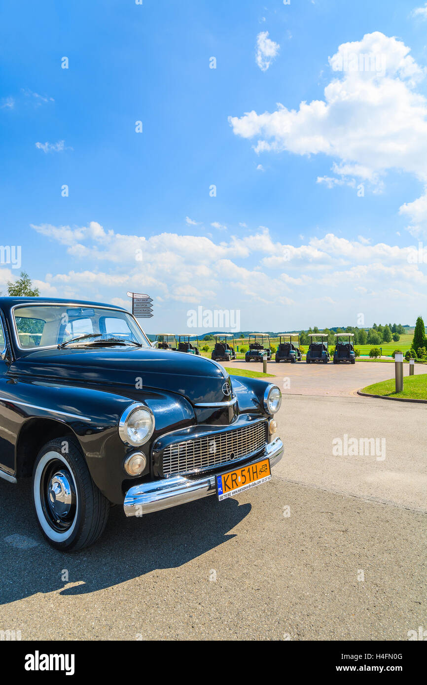 PACZULTOWICE GOLF CLUB, POLAND - AUG 9, 2014: old black classic car parks on street in Paczultowice Golf Club. Vintage cars are popular to drive people to weeding ceremony. Stock Photo