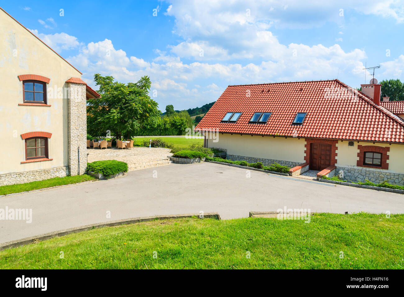 Restaurant building with chairs and tables on sunny terrace in Paczultowice village, Poland Stock Photo