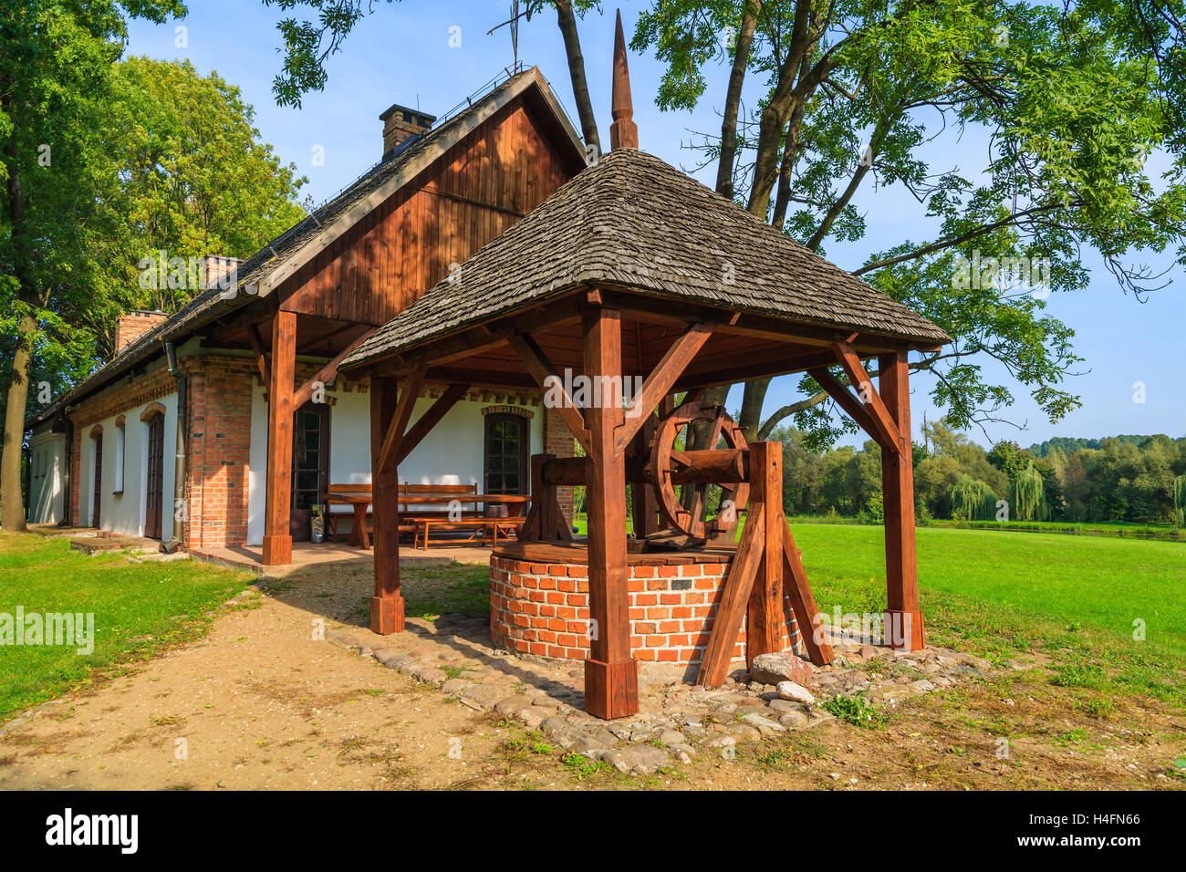 Water well of a traditional rural house in Radziejowice village on sunny summer day, Poland Stock Photo