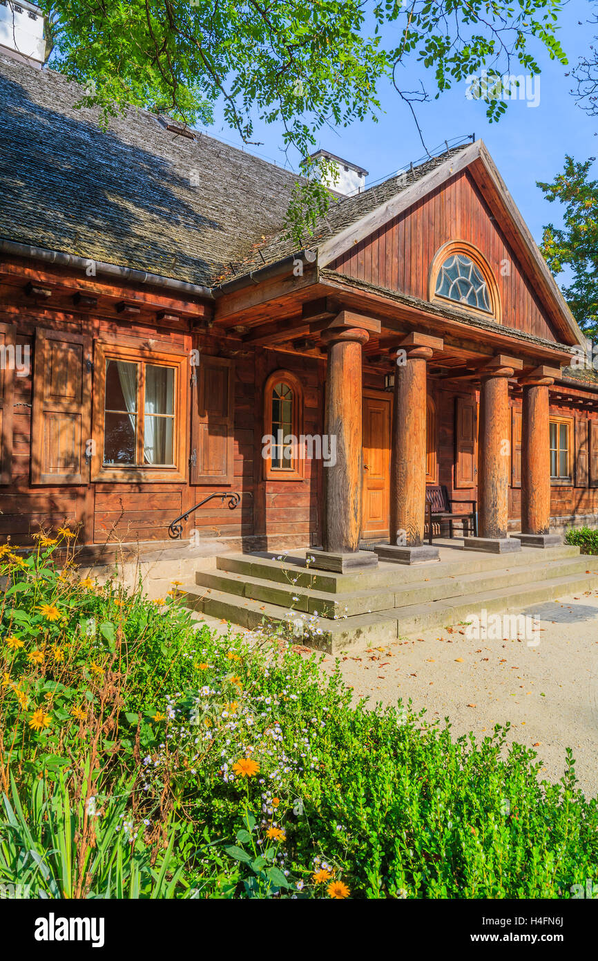 Front view of traditional wooden cottage house in rural area of Radziejowice village, Poland Stock Photo